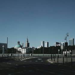 Empty road with buildings in background