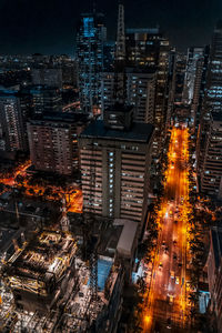 Aerial view of city lit up at night