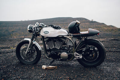 Close-up of motorcycle against sky