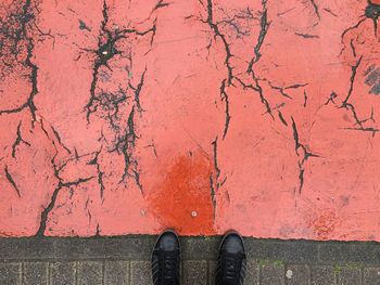 Low section of person standing on footpath