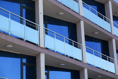 Low angle view of modern building against blue sky