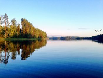 Scenic view of lake against clear blue sky