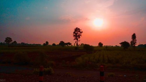 Scenic view of field against sky during sunset