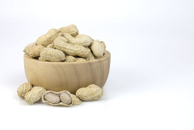Close-up of bread in bowl against white background