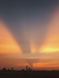 Scenic view of silhouette landscape against orange sky