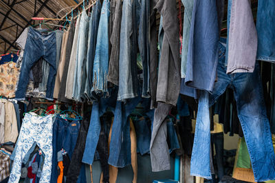 Clothes hanging in row at market