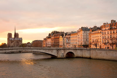 View of bridge over river against cloudy sky