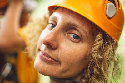 Close-up portrait of woman wearing hardhat