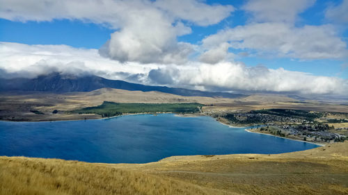 Panoramic view of land and sea against sky