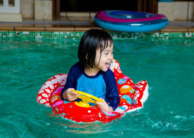 Smiling girl in swimming pool