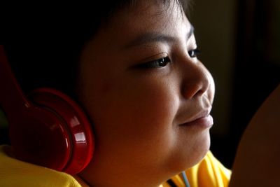 Close-up of boy listening to headphones