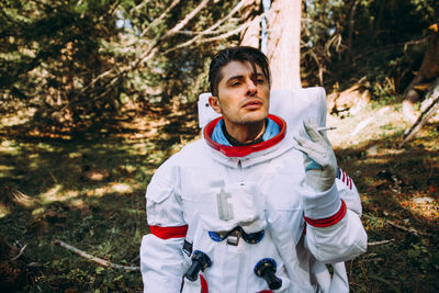 Astronaut smoking in forest