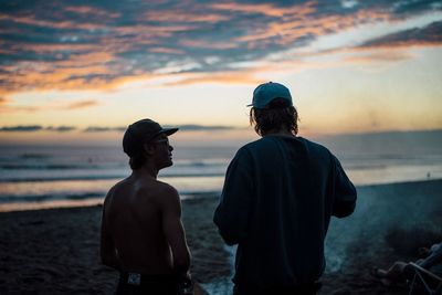 Rear view of men on beach