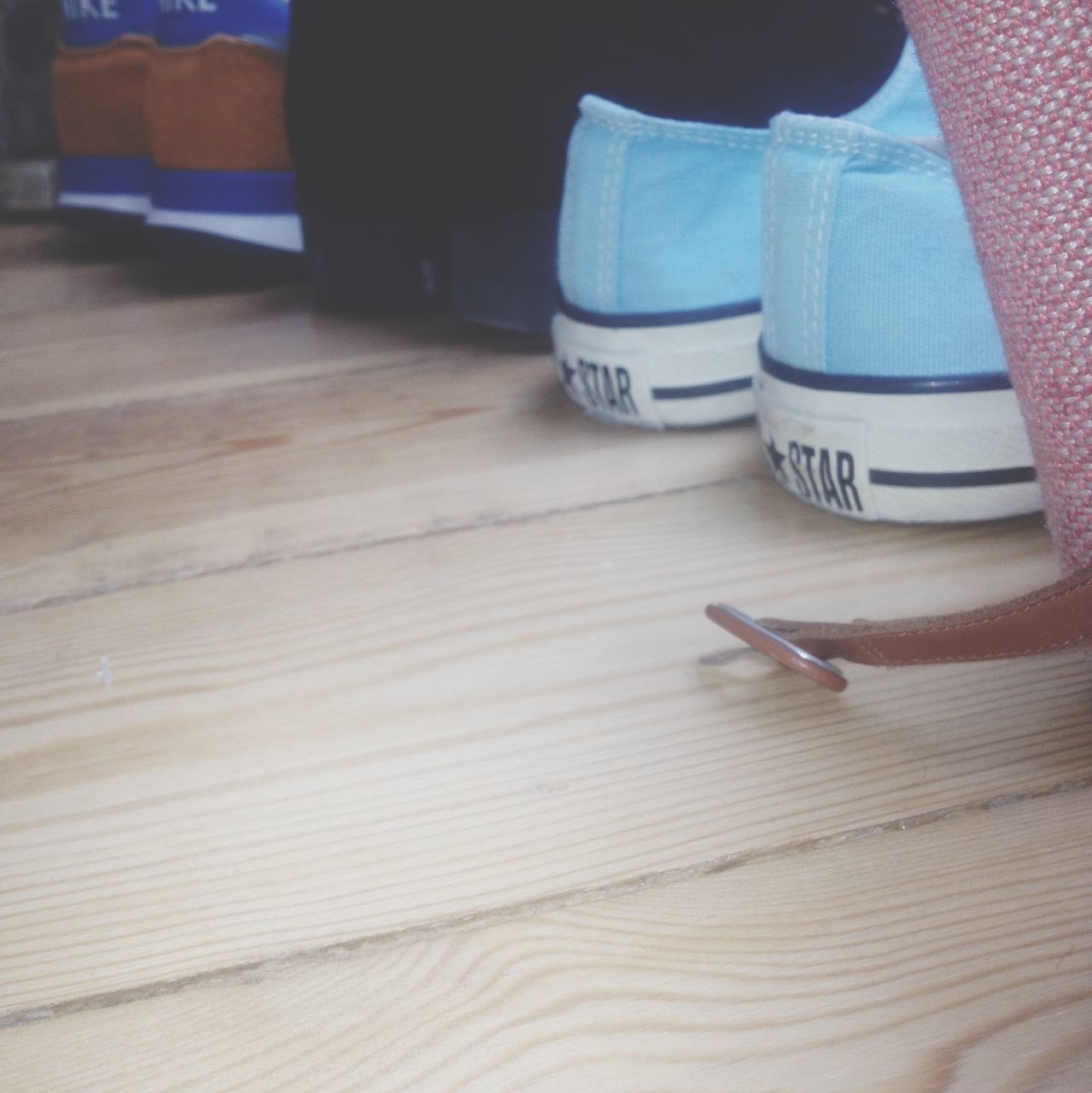 low section, indoors, person, wood - material, lifestyles, high angle view, part of, unrecognizable person, leisure activity, men, human foot, table, wooden, hardwood floor, shoe, cropped