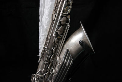 Close-up of scarf on saxophone against black background
