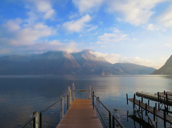 Pier over lake against mountains