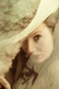 Close-up portrait of woman wearing hat