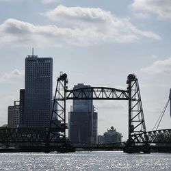 Bridge over river with buildings in background