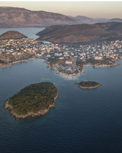 High angle view of sea and mountains against sky