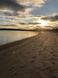 Scenic view of beach against sky during sunset