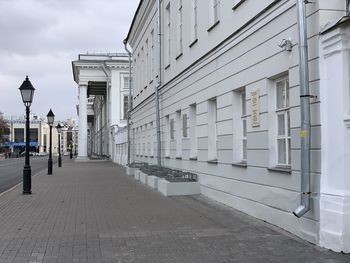 Street amidst buildings against sky in city