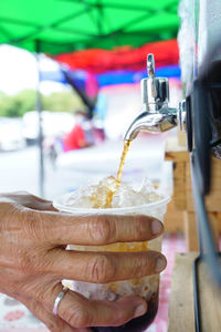 Close-up of hand holding drink