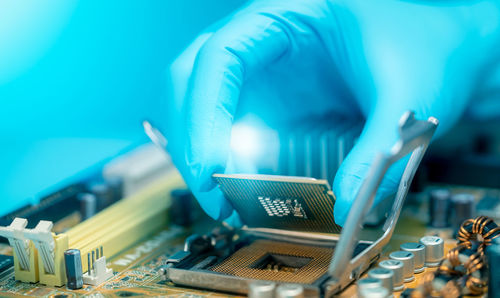 Cropped hand of person working in factory