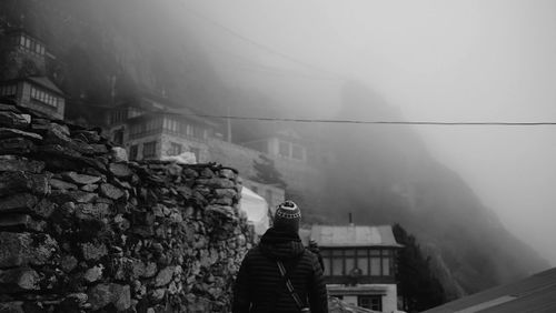 Man standing on mountain against sky