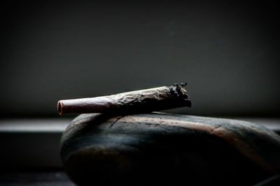 Close-up of cigarette smoking on table