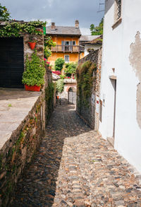 Footpath amidst houses and buildings in town