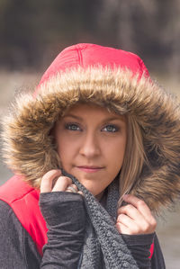 Close-up portrait of young woman in warm clothing