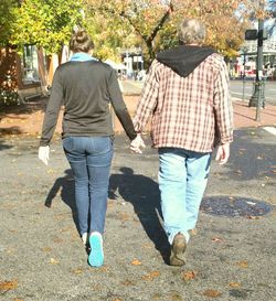 Rear view of woman walking on street