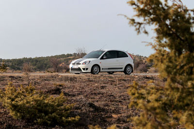 Vintage car on land against clear sky