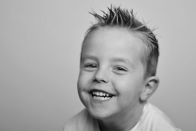 Portrait of smiling boy against white background