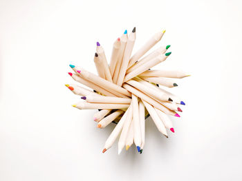 Close-up of colored pencils against white background