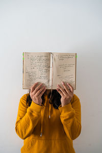 Girl with notes close up with yellow hoodie