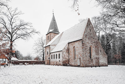 Building against sky during winter