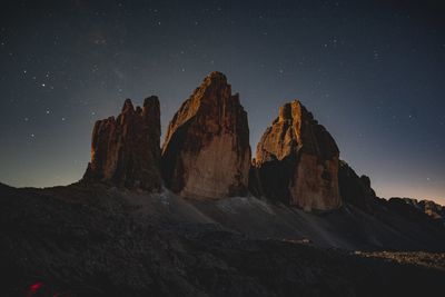 Rock formation against sky at night