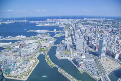 High angle view of city by river against sky