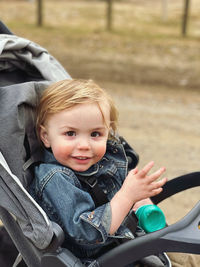 Portrait of cute boy sitting on chair