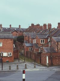 Houses in town against clear sky