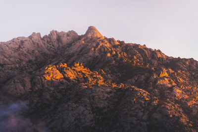 Low angle view of rock formation against clear sky