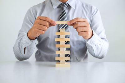 Midsection of man sitting on table