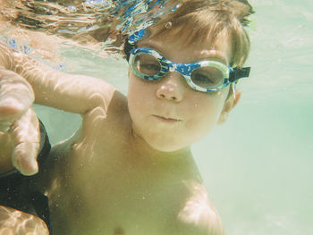 Portrait of boy swimming underwater