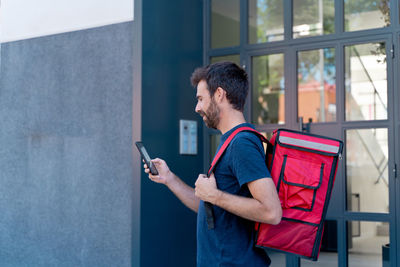 Side view of man using mobile phone