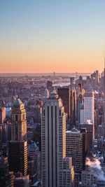 High angle view of buildings in city during sunset