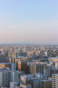 High angle view of buildings in city against clear sky
