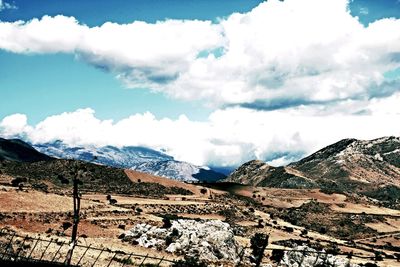 Scenic view of mountains against cloudy sky