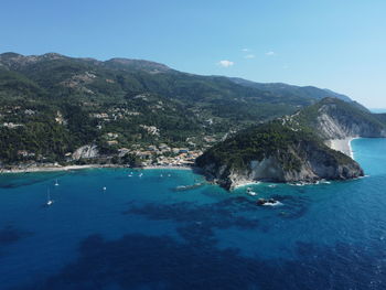 Scenic view of sea and mountains against sky