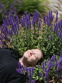 Portrait of woman standing amidst plants